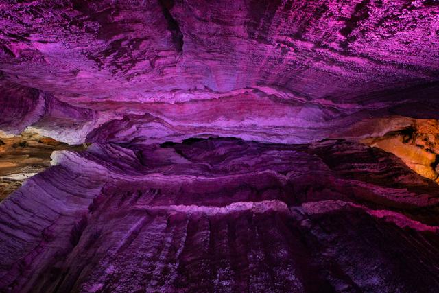 Layered rock ceiling of the Ruby Falls cave inside Lookout Mountain, Chattanooga, Tennessee, lit in purple
